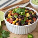 Spicy southwest dense bean salad recipe served in white bowl