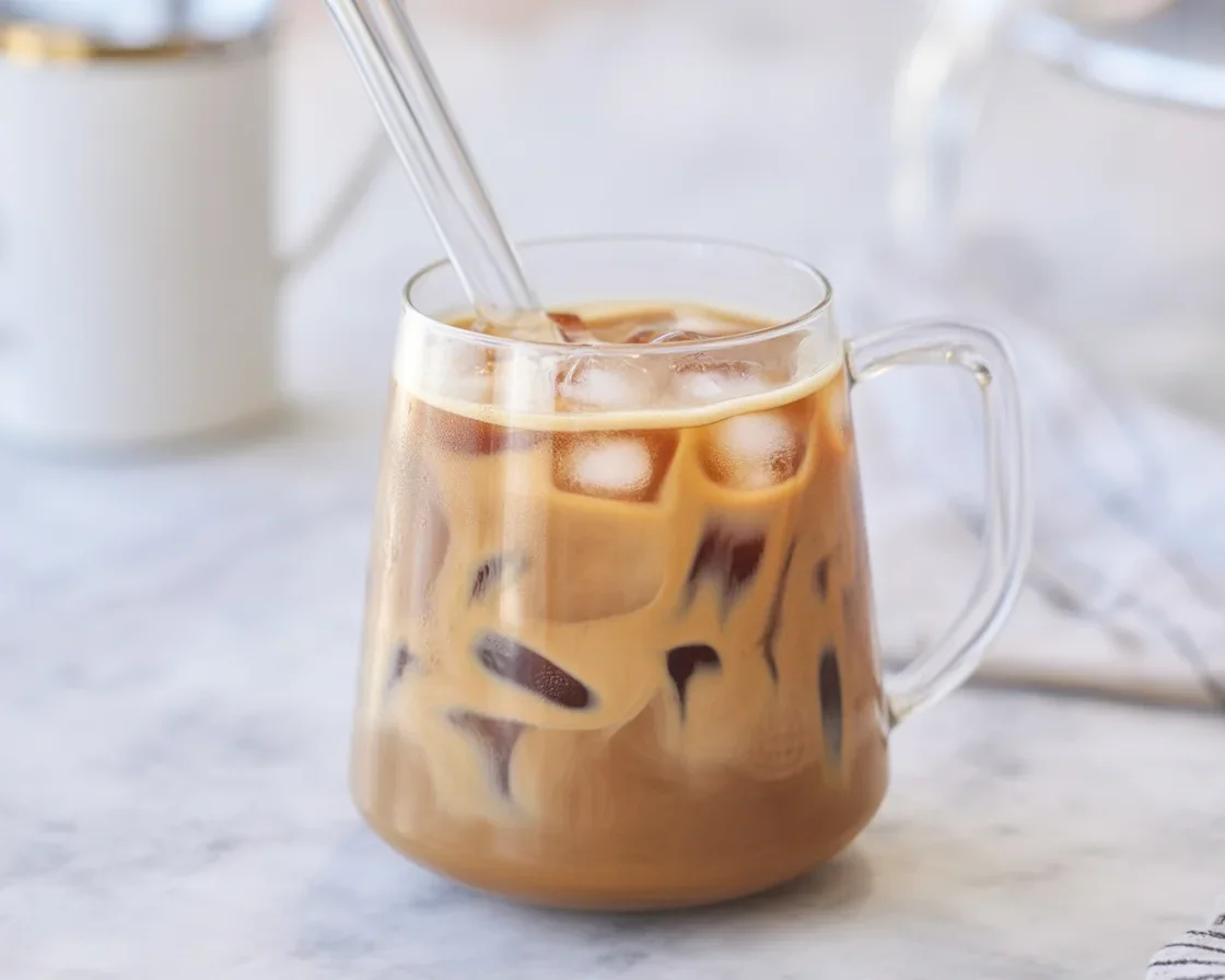 Iced coffee featuring tahini, sweeteners, and a creamy texture served in a glass.
